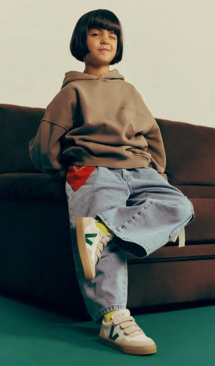Four kids wearing Veja sneakers